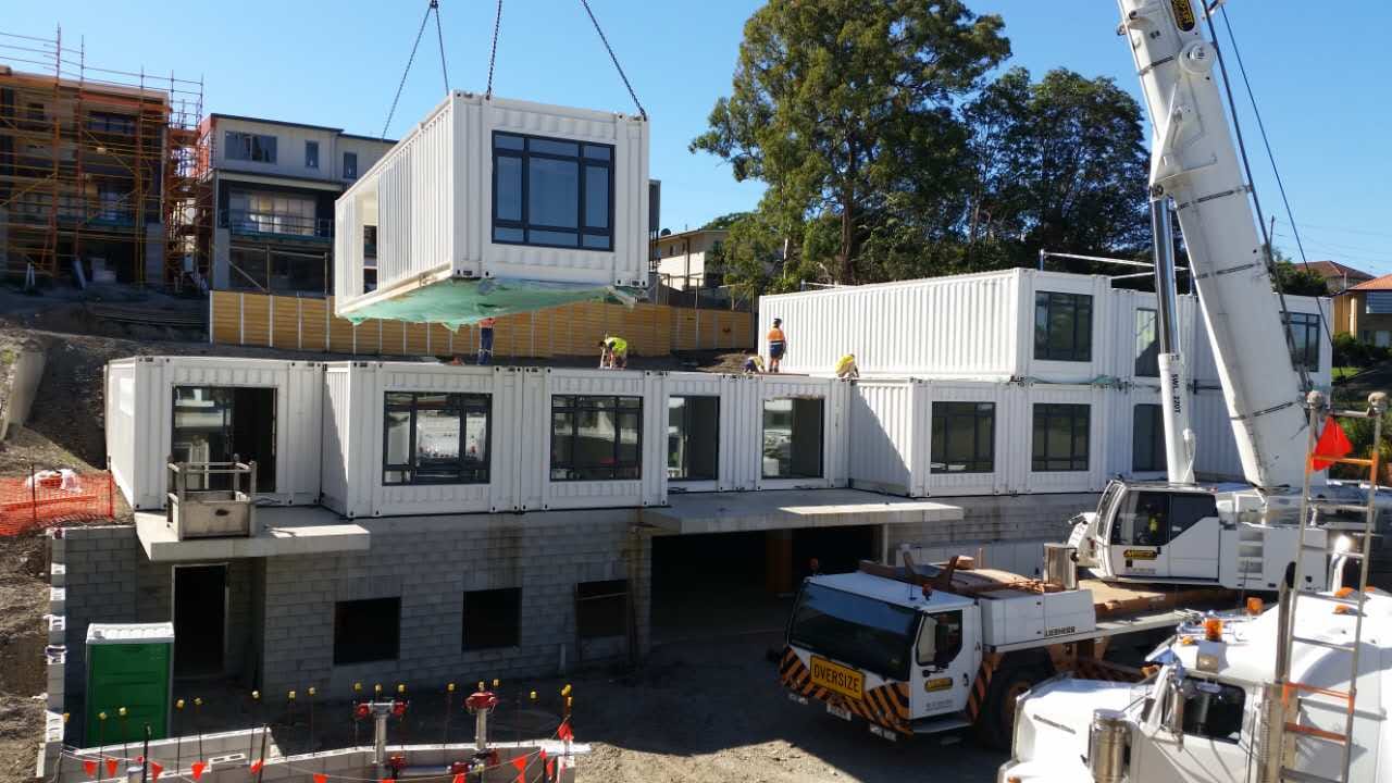 Modular apartment modules craned into place on an Australian site